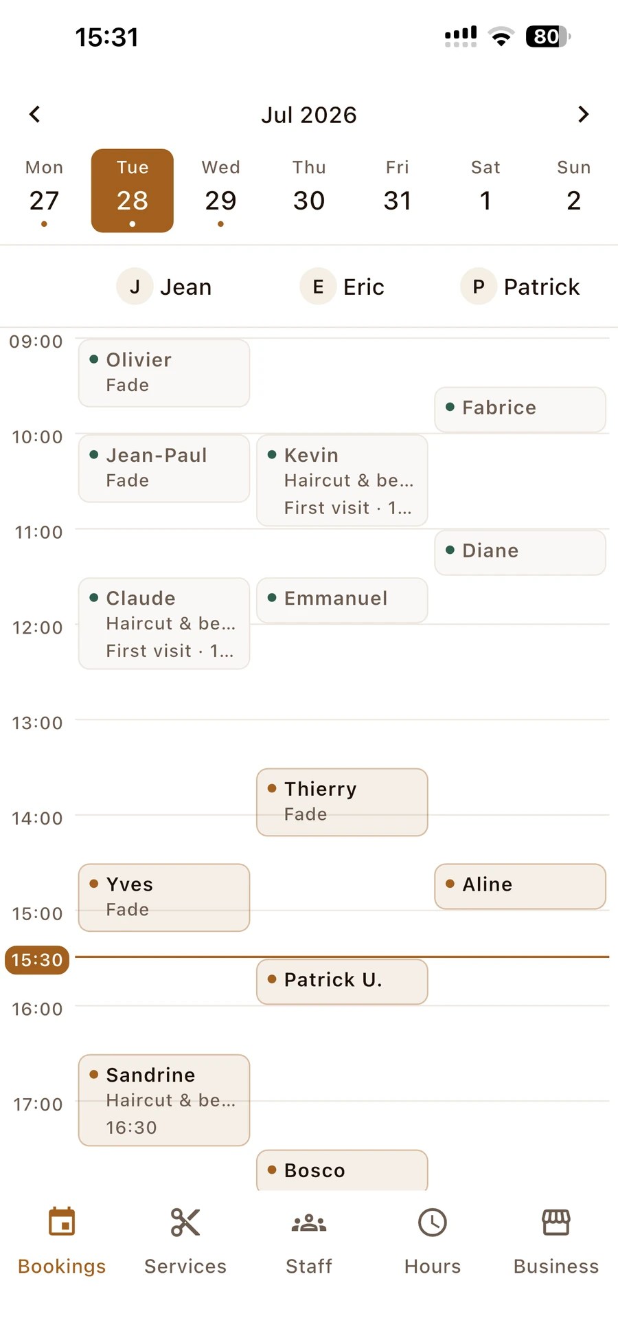 The YOZA provider app calendar, filled with a full day of booked appointments across staff